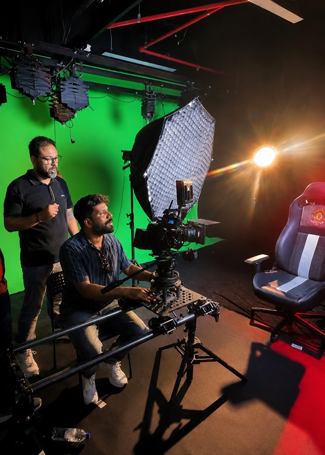 Hossam Nageeb on set beside the camera operator, with studio lighting and a green screen
